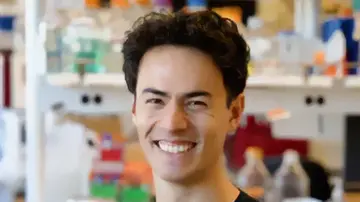 Portrait of Pascal Sturmfels smiling into the camera in a lab