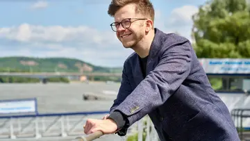 Wolfram Barfuss smiling leaning over a railing