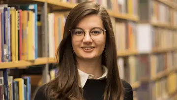 Portrait of Barbara Betti in front of bookshelf's