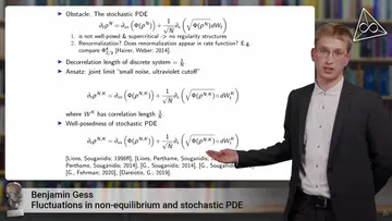 Benjamin Gess is giving a lecture, in the background his presentation