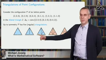 Michael Joswig is giving a lecture, in the background his presentation