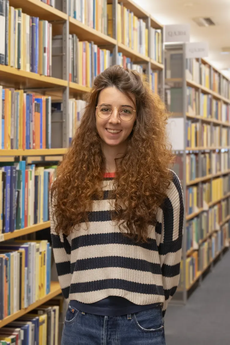 Portrait of Lisa Seccia in front of bookshelves