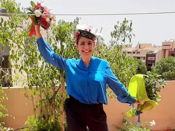 Photo of Raffaella Mulas with two bouquets of flower in her hands