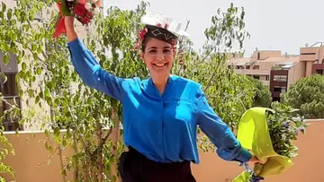 Photo of Raffaella Mulas with two bouquets of flower in her hands