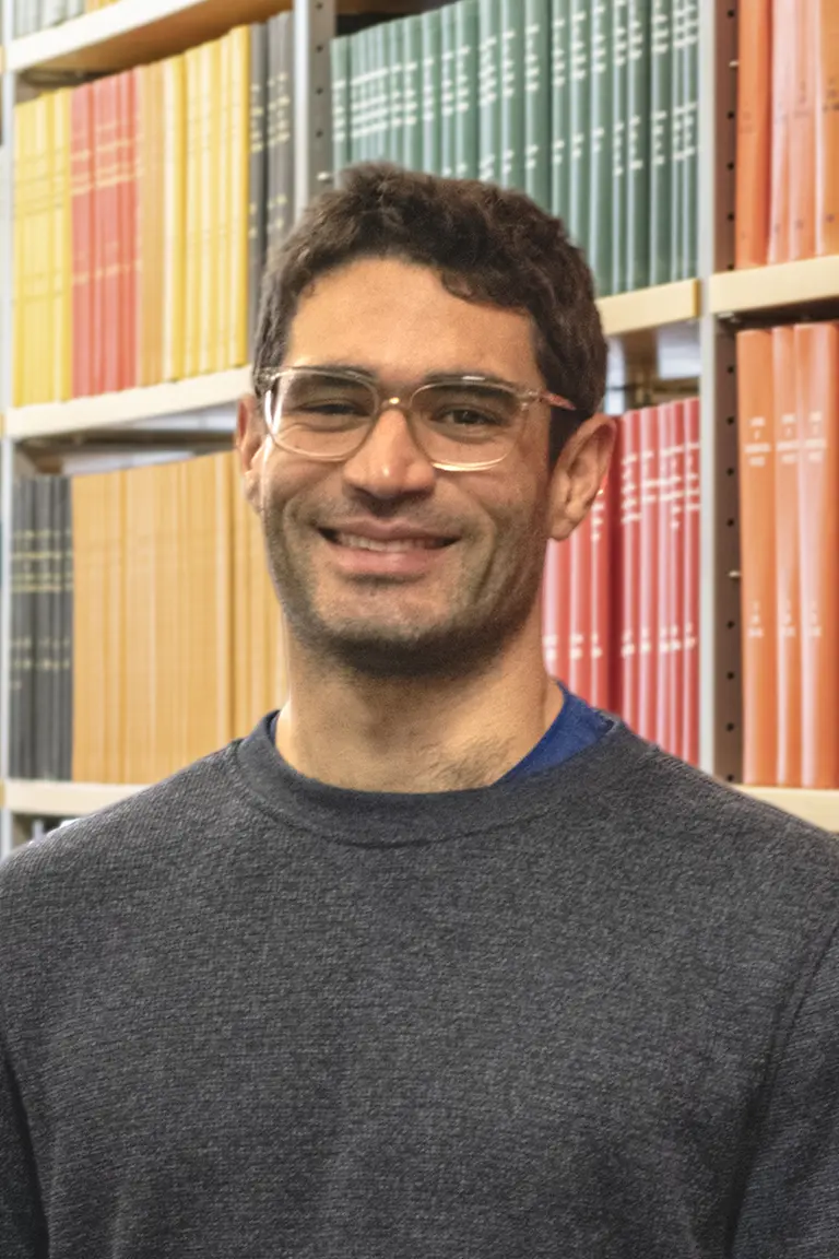 Portrait of James R Farre in front of bookshelves
