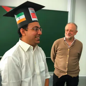 Pradeep Banerjee with his doctoral hat next to Jürgen Jost
