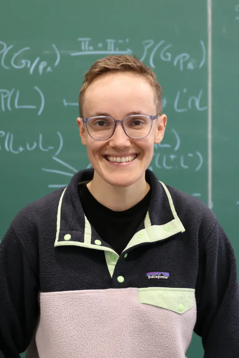 Portrait of Laura Lankers in front of a blackboard