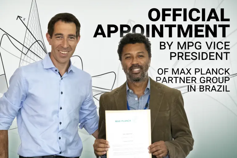MPG vice president Klaus Blaum with Christian Rodrigues, who is holding his Letter of Appointment. Includes the text "Official Appointment by MPG vice president of Max Planck Partner Group in Brazil"